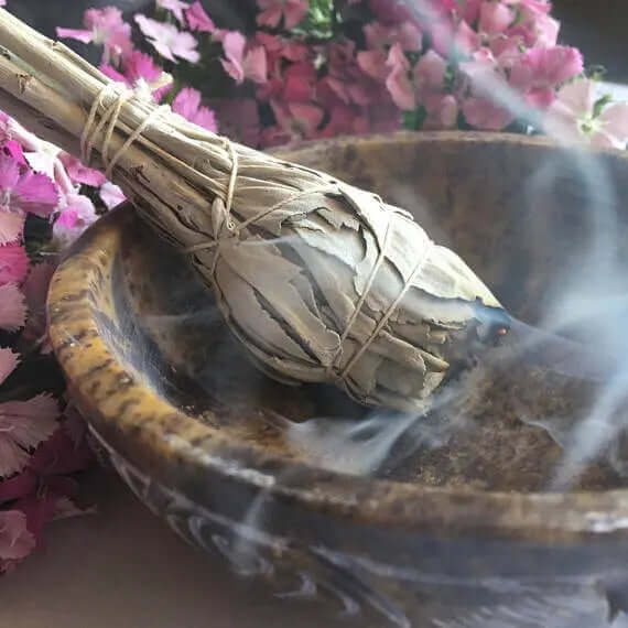 Sage herb bundle in a bowl for smoke cleansing